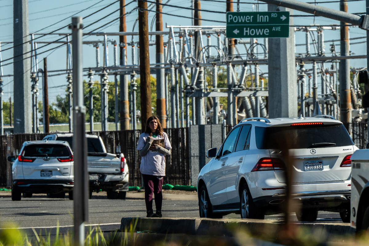 Califia Carlisle holds a handmade sign in October while asking for money at the intersection of Power Inn Road and Howe Avenue in Sacramento. Her boyfriend, Justin Hartung, said she wakes up early every morning, puts on her makeup and goes out to what she calls “her job.”